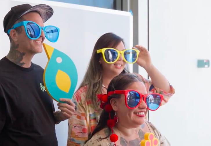 UXHI members at photobooth with sunglasses
